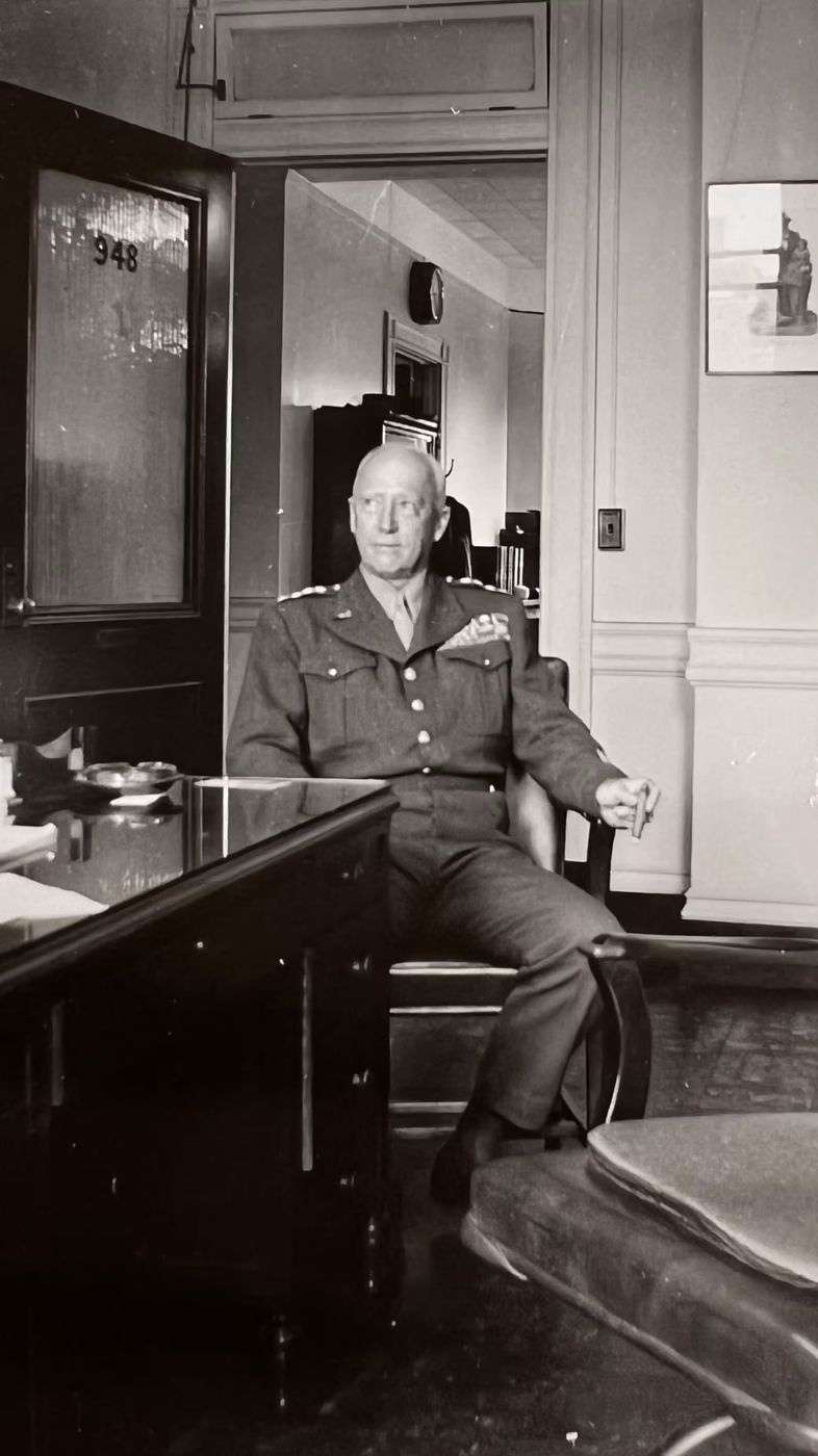 At his desk.